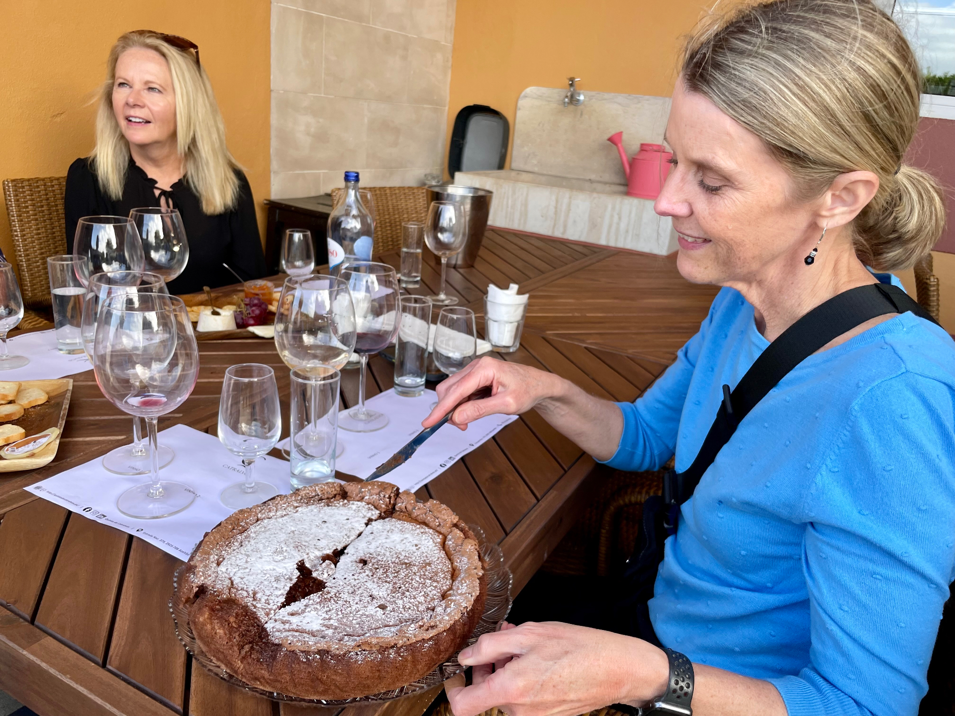 Chocolate cake and empty tasting glasses at a private wine table