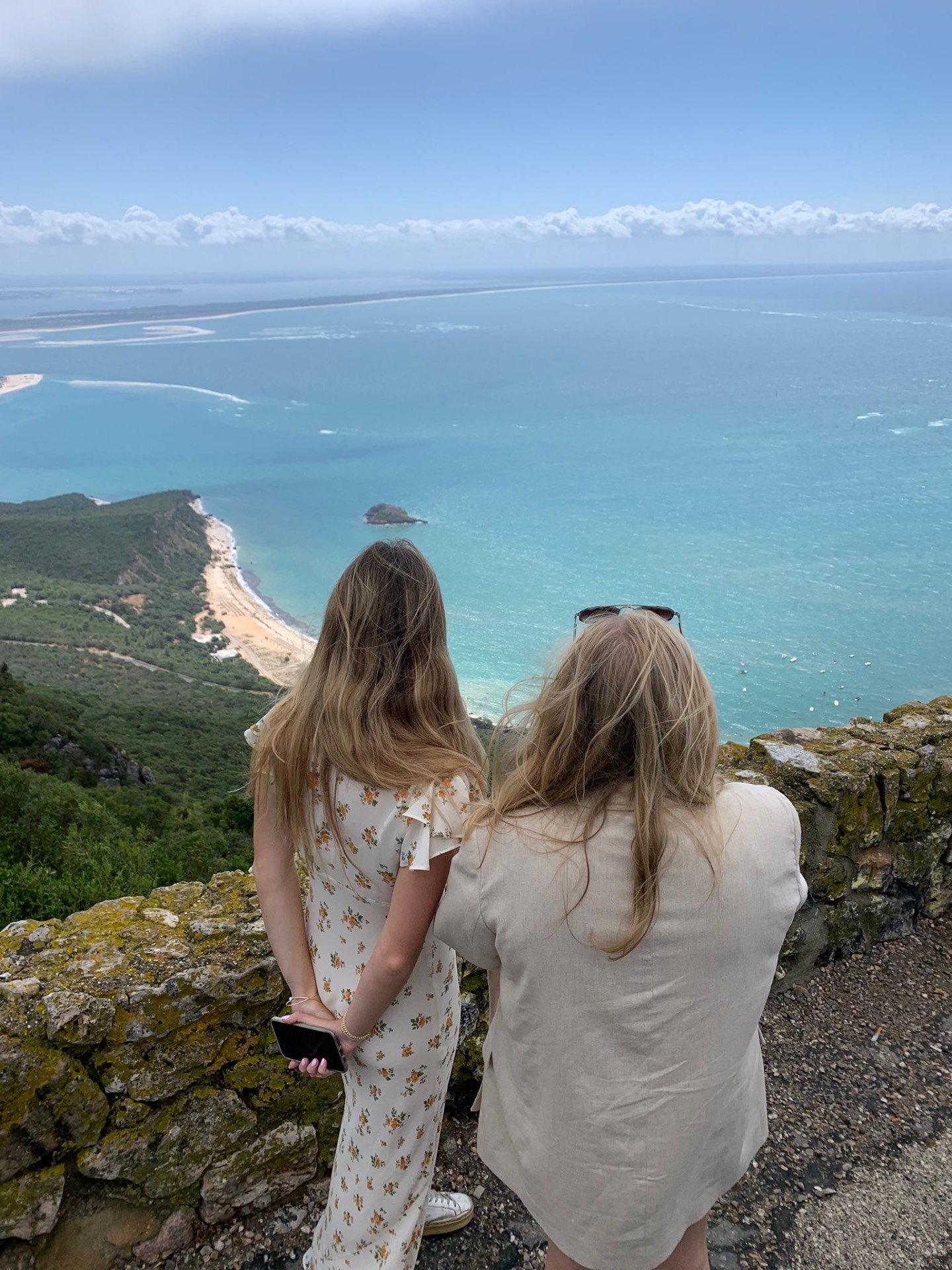 Two friends pausing together above the Arrábida coast during a private day.